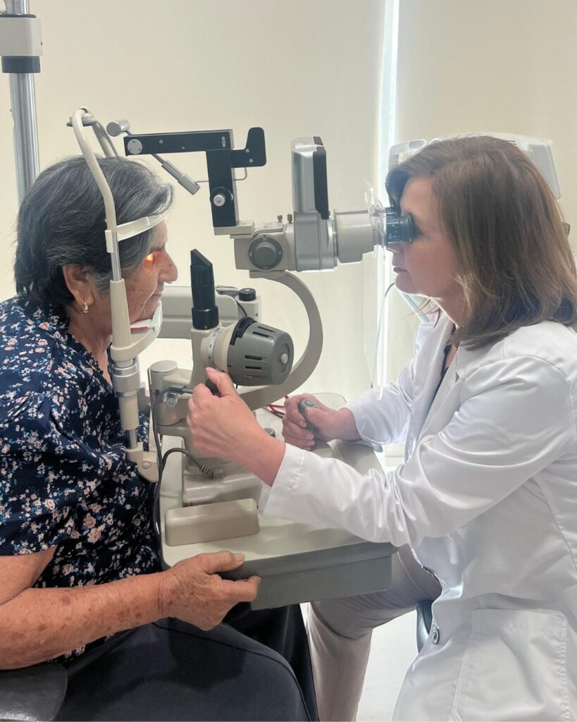 Dra. Marina Ramírez revisando los ojos del paciente en tijuana